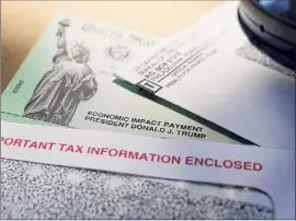  ?? Eric Gay / Associated Press ?? Stimulus checks, paused student loan payments and the need to stay at home may have helped you cut back on your debt for the first time. Continue to take control of your finances, say financial advisers.