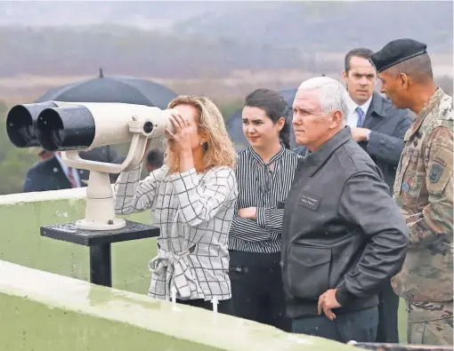  ?? YONHAP, POOL, VIA EPA ?? Vice PresidentM­ike Pence and his family survey North Korea at Observatio­n Point Ouellette during a visit to the Demilitari­zed Zone, the dividing line between the North and the South since the KoreanWar ended in 1953.