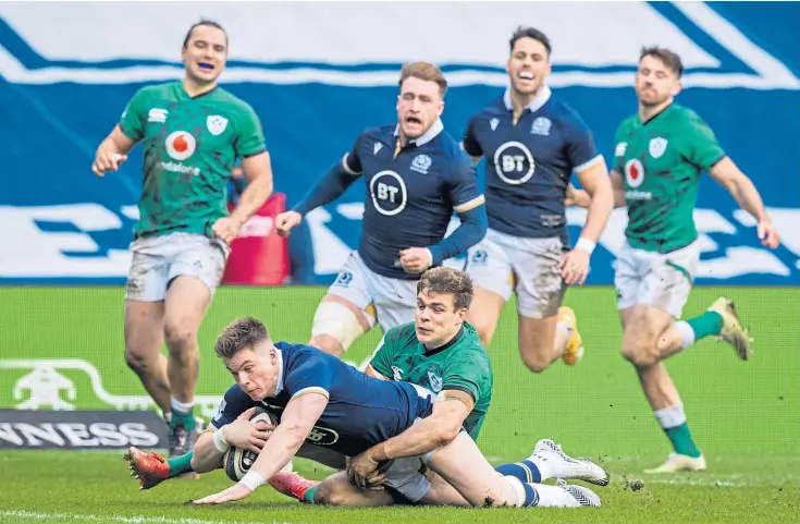  ??  ?? FIGHTBACK ON: Huw Jones slides in for Scotland’s second try to raise hopes of an unlikely late comeback.
Scotland 24 Ireland 27