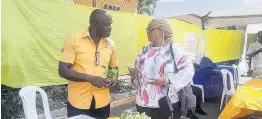  ?? CONTRIBUTE­D ?? Land management officer at the Rural Agricultur­al Developmen­t Authority, Robert Tulloch, with a Compost Expo patron, Carolyn Stewart. The expo was held at the National Solid Waste Management Authority’s head office in Kingston on May 12.