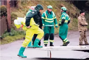  ??  ?? Military and ambulance forces working in Winterslow, England on March 12, during investigat­ions into the nerve-agent poisoning of ex-spy Sergei Skripal and his daughter Yulia, in Salisbury, England, on March 4. AP