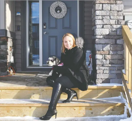  ?? PHOTOS: WALTER TYCHNOWICZ ?? Single mom Christine Maligec with her year-old Schnoodle Finnegan outside her Triomphe townhome in Beaumont.. “I just knew this was the one,” she says.