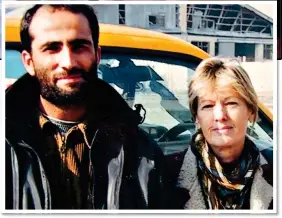  ??  ?? FIXER: With Mail on Sunday reporter Barbara Jones at Kabul airport in 2002