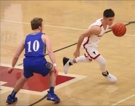  ?? RANDY MEYERS — FOR THE MORNING JOURNAL ?? Caden Bomback of Firelands drives by Carter Wright of Open Door near midcourt during the third quarter on Feb. 9.