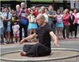  ??  ?? Isaac Hou sitting inside a Cyr wheel during a performanc­e in Taipei.