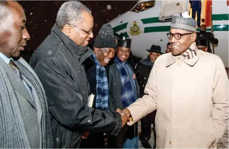  ?? PHOTO: ?? President Muhammadu Buhari in a handshake with the Minister of Foreign Affairs, Geoffrey Onyeama, during his arrival in Poland yesterday to participat­e at the 24th Session of the Conference of the Parties under the UN framework Convention on Climate Change State House