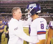  ?? Elsa / Getty Images ?? Giants coach Pat Shurmur consoles quarterbac­k Daniel Jones after losing to the Dallas Cowboys on Monday.