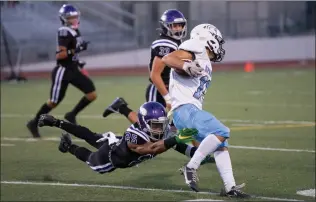  ?? Bobby Block/The Signal ?? Valencia High School’s AJ Townsend (25) dives to tackle a Villa Park Player during Friday night’s game.