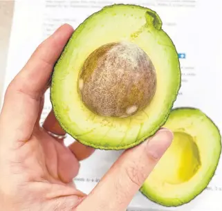  ??  ?? It's easy to enjoy an avocado if you know a few tricks to selecting ripe fruit and removing the pit.