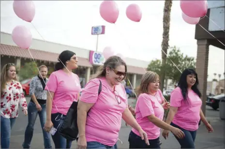  ?? VINCENT OSUNA PHOTO ?? Participan­ts make their way down Heber Avenue during the sixth annual Lazo Rosa Binacional walk in Calexico on Wednesday morning.