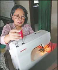  ??  ?? Parahita Satiti, who hopes to get extra income after her office cut her monthly allowance by half during the pandemic, makes traditiona­l Javanese women’s clothings.