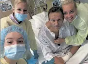  ?? NAVALNY INSTAGRAM VIA AP ?? This handout photo published Tuesday by Russian opposition leader Alexei Navalny on his instagram account, shows himself, center, and his wife Yulia, right, daughter Daria, and son Zakhar, top left, at a hospital in Berlin, Germany.