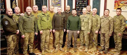  ?? — AFP photos ?? The Ukrainian President Volodymyr Zelensky (sixth right) with newly appointed Commander-in-Chief of the Armed Forces of Ukraine Oleksandr Syrsky (seventh right) and Minister of Defence of Ukraine Rustem Umerov (seventh le ) with other miliraty members during their counsel in Kyiv.