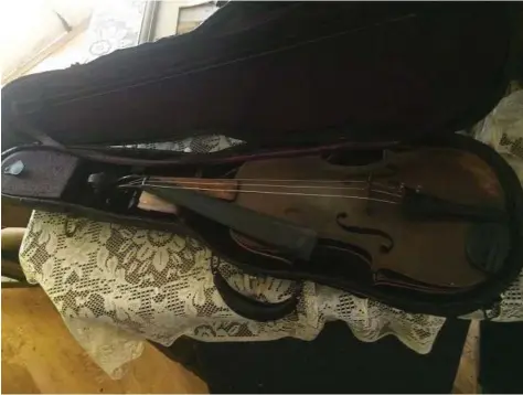  ?? Courtesy photo ?? The one heirloom Chris Svahn had hoped would survive Harvey, recovered from his flooded home in Dickinson on Wednesday, was his late father’s violin.