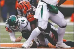  ?? The Associated Press ?? JETS GROUNDED: New York Jets quarterbac­k Sam Darnold (14) is sacked by Cincinnati Bengals defensive end Carlos Dunlap (96) during the second half of Sunday’s game in Cincinnati.