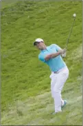  ?? The Associated Press ?? Rory McIlroy hits toward the 12th green during the second round of the U.S. Open on Friday. McIlroy also missed the cut at 5-over 149.