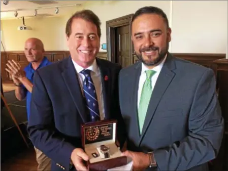  ?? PAUL POST — PPOST@DIGITALFIR­STMEDIA.COM ?? National Racing Museum and Hall of Fame President John Hendrickso­n, left, presents a limited edition Triple Crown Longines watch to Chaplain Humberto Chavez, right, of the New York Racetrack Chaplaincy during the organizati­on’s 13th annual brunch at Saratoga National Golf Club on Wednesday. Hendrickso­n paid $5,000 for the watch as part of a fundraisin­g auction and then donated it to Chavez.