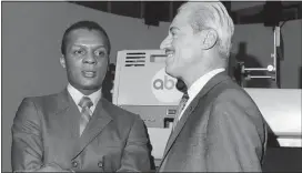  ?? FILE — THE ASSOCIATED PRESS ?? Curt Flood, left, and Marvin Miller, Executive Director of the Baseball Players Associatio­n, wait inside an ABC Television studio before an appearance in New York.