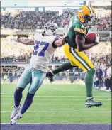  ?? Tom Pennington / Getty Images ?? Green Bay’s Davante Adams pulls in the gamewinnin­g touchdown against Dallas’ Jourdan Lewis with 11 seconds remaining, carrying the Packers past the Cowboys 35-31.