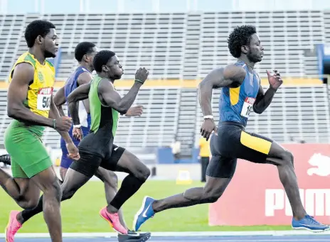  ?? PHOTOS BY RICARDO MAKYN/CHIEF PHOTO EDITOR ?? Elite Performanc­e track club’s Javorne Dunkley (right) steps away from his challenger­s during the running of the 100 metres at the Carifta Trials inside the National Stadium yesterday.