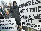  ?? MICHAEL DWYER/ASSOCIATED PRESS ?? Federal workers and supporters protest the government shutdown Friday in Boston. The shutdown began Dec. 22.