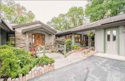  ?? Photos by Sophia Constantin­e/Roohan Realty ?? The home was built into a hillside and incorporat­es natural elements including stone and water.