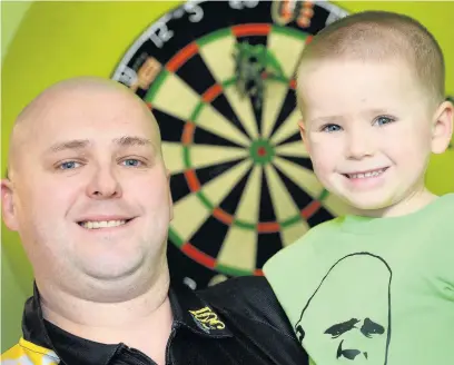  ?? Dominic Salter ?? ●●Darts whizz Mason Foulkes with dad Lee Foulkes