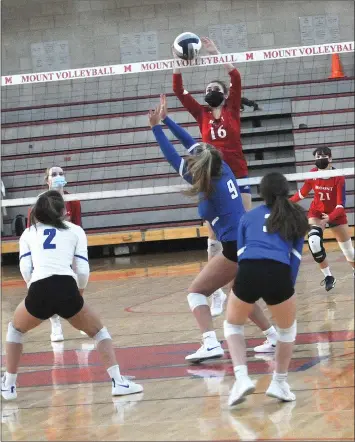  ?? Photo by Ernest A. Brown ?? Mount St. Charles senior Lauren Cunanan, above, blocks a ball back toward Cumberland junior middle blocker Nicole DiSalvo (9) in both teams’ first match in nearly 18 months Friday night in Woonsocket.