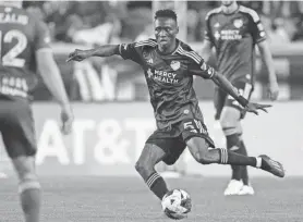  ?? ALBERT CESARE/THE ENQUIRER ?? FC Cincinnati midfielder Obinna Nwobodo passes during the first half of his team’s MLS playoff match against the Red Bulls on Saturday in Harrison.