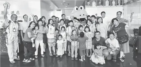  ??  ?? The children and their parents get their picture taken with Visit Sibu Year 2017 Mascot Bubu.