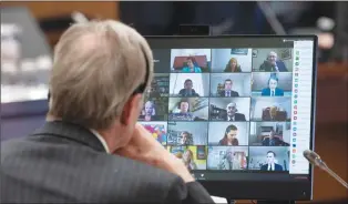  ?? Canadian Press photo ?? Canadian Members of Parliament are shown on a monitor during a virtual session of the House of Commons Tuesday in Ottawa.