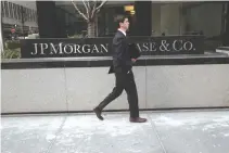  ??  ?? A MAN walks past the JPMorgan Chase & Co. headquarte­rs in New York City. The bank’s deposits have grown faster than its competitor­s’ in the last five years.