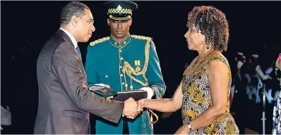  ?? CONTRIBUTE­D ?? Prime Minister Andrew Holness (left) presents Artistic director and founder of Khulcha Theatre School of Dance, Carolyn Russell Smith, with the Prime Minister’s Jamaica 55 Commemorat­ive Medal of Appreciati­on for Service to Education and the Creative...