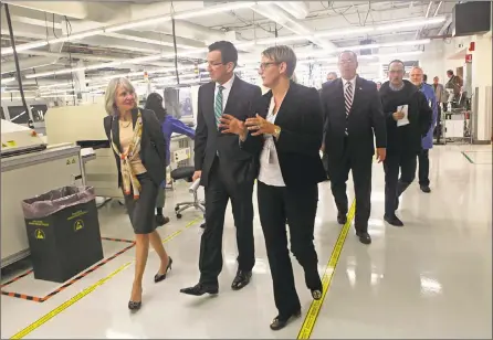  ?? Hearst Connecticu­t Media file photos ?? Former Gov. Dannel P. Malloy on a 2014 tour of Microboard Processing in Seymour, among some 1,900 companies to receive state financing under Malloy’s Small Business Express program.