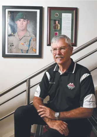  ??  ?? HERO: Doug Baird in front of a picture of his son, VC recipient Corporal Cameron Baird.