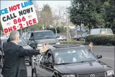  ?? Robert Gauthier Los Angeles Times ?? MIKE McCOY calls attention to his ICE sign outside Los Alamitos City Hall on Monday where the council voted to go against the state.