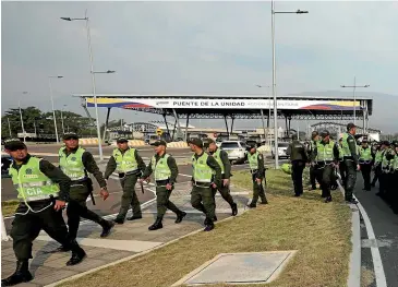  ?? AP ?? Colombian police arrive at the Tienditas Internatio­nal Bridge to provide security at the site of the Venezuela Aid Live concert on the outskirts of Cucuta, Colombia, on the border with Venezuela.