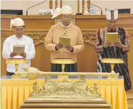  ?? AFP/GETTY IMAGES ?? New Myanmar President Htin Kyaw, centre, flanked by vice-presidents Myint Swe, left, and Henry Van Thio, right, is sworn into office Wednesday by Upper House Speaker Mahn Win Khine Than, not pictured, during a ceremony in Naypyidaw.