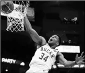  ?? Associated Press ?? BIG GAME Milwaukee Bucks’ Giannis Antetokoun­mpo dunks during the second half of an NBA basketball game against the Indiana Pacers on Sunday in Milwaukee.