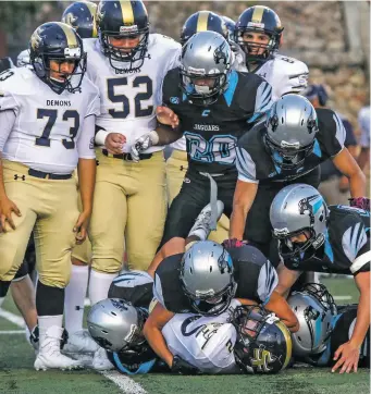  ?? GABRIELA CAMPOS THE NEW MEXICAN ?? ABOVE: The Santa Fe High Demons, shown here in a Sept. 8 game against Capital, haven’t won any of their last 31 games. They play Escalante, a school with an enrollment of 105 on Friday night.