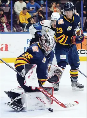  ?? DAVID CROMPTON/The Okanagan Weekend ?? Vernon Vipers goalie Riley Herbst makes a save as defenceman Brendan Kim and Penticton Vees forward Jackson Niedermaye­r look on Friday at the SOEC. Penticton Vees captain David Silye battles with Vernon Vipers forward Dawson Holt Friday at the SOEC.