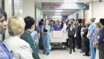  ?? University Medical Center ?? University Medical Center staff hold a “donor walk” Wednesday for crash victim Michael Sigler. The donor walk was the first to be held at the hospital to honor someone whose organs are being donated, Sigler’s 43-year-old mother said.