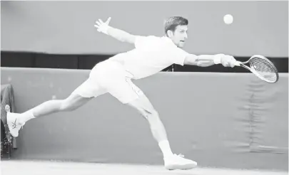  ?? (AP) ?? SERBIA’S Novak Djokovic returns the ball to Kyle Edmund of Great Britain, during their men’s singles match on the sixth day of the Wimbledon Tennis Championsh­ips in London. Djokovic won, 4-6, 6-3, 6-2, 6-4.