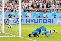  ?? PAVEL GOLOVKIN/ASSOCIATED PRESS ?? Iran goalkeeper Ali Beiranvand tumbles to the turf after failing to stop a shot by Portugal’s Ricardo Quaresma during Monday’s match in Saransk, Russia.