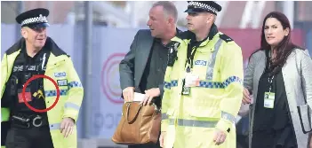  ??  ?? Taking no chances: Police officers armed with Tasers, circled, escort Jewish MP Luciana Berger at the Labour Party conference in Liverpool yesterday