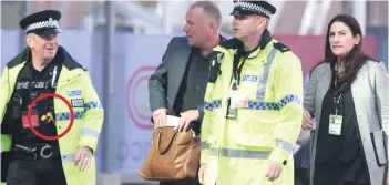  ??  ?? Taking no chances: Police officers armed with Tasers, circled, escort Jewish MP Luciana Berger at the Labour Party conference in Liverpool yesterday