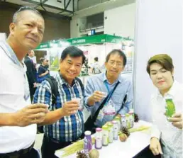  ??  ?? Philippine attendees at the trade show sample rice milk drink.