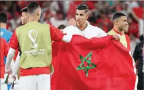  ?? (AFP) ?? Morocco’s players celebrate their team’s win in the FIFA World Cup Qatar 2022 Group F match over Belgium at the Al Thumama Stadium in Doha on Sunday.