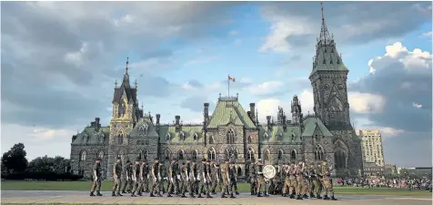  ?? TONY CALDWELL/POSTMEDIA NETWORK ?? The The Ceremonial Guard held a full dress rehearsal of the 21st annual Fortissimo celebratio­n on Parliament Hill in Ottawa Ontario Wednesday July 19. Federal opposition parties have called for an emergency meeting of parliament to discuss Canada’s...