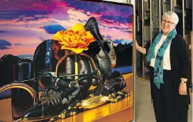  ??  ?? Donna Livingston­e, chief executive officer of Glenbow, with one of the museum’s 33,000 works of art.